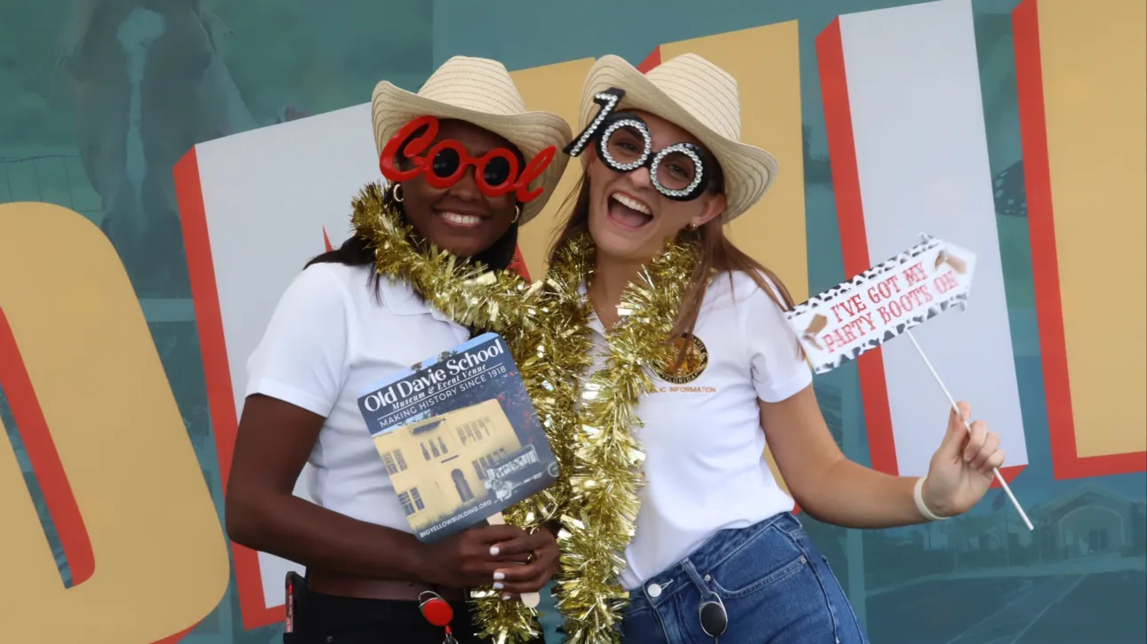 Two guests using a South Florida photo booth rental at an event