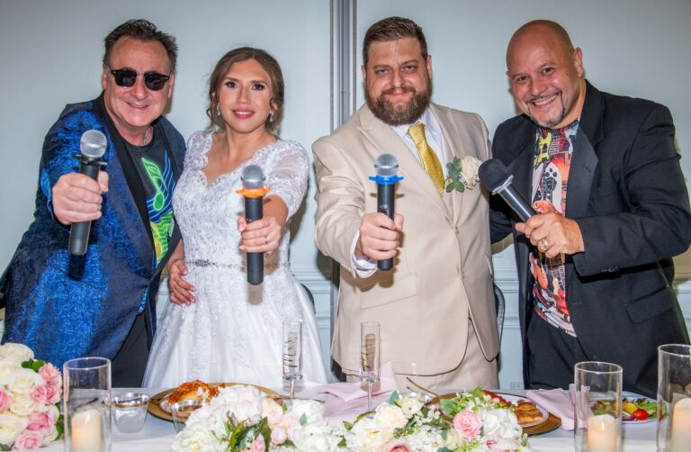 A group of people holding MC microphones.