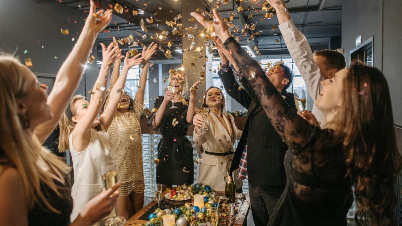 A group of people celebrating around a table.