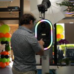 Guy entering his phone number in photo booth.