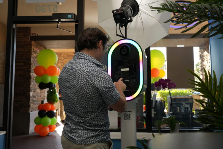 Guy entering his phone number in photo booth.