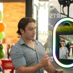 Second picture of Thomas Steckman next to a photo booth.