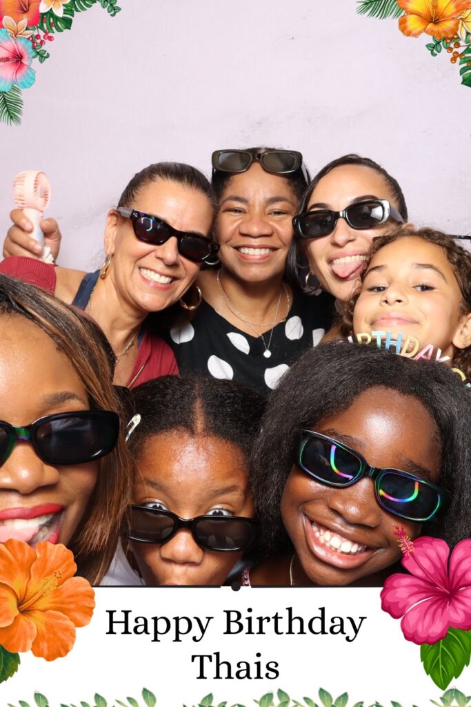 Group of guests in prop sunglasses at a birthday party photo booth