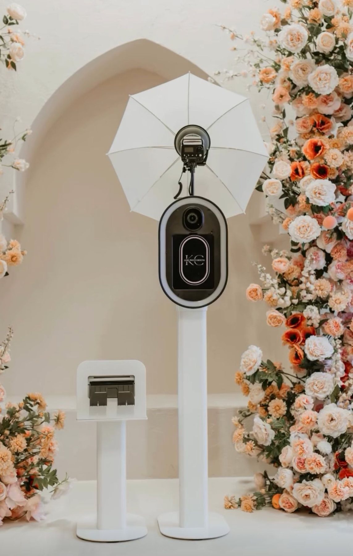 Motion classic photo booth set up beside a floral arch at a South Florida wedding reception