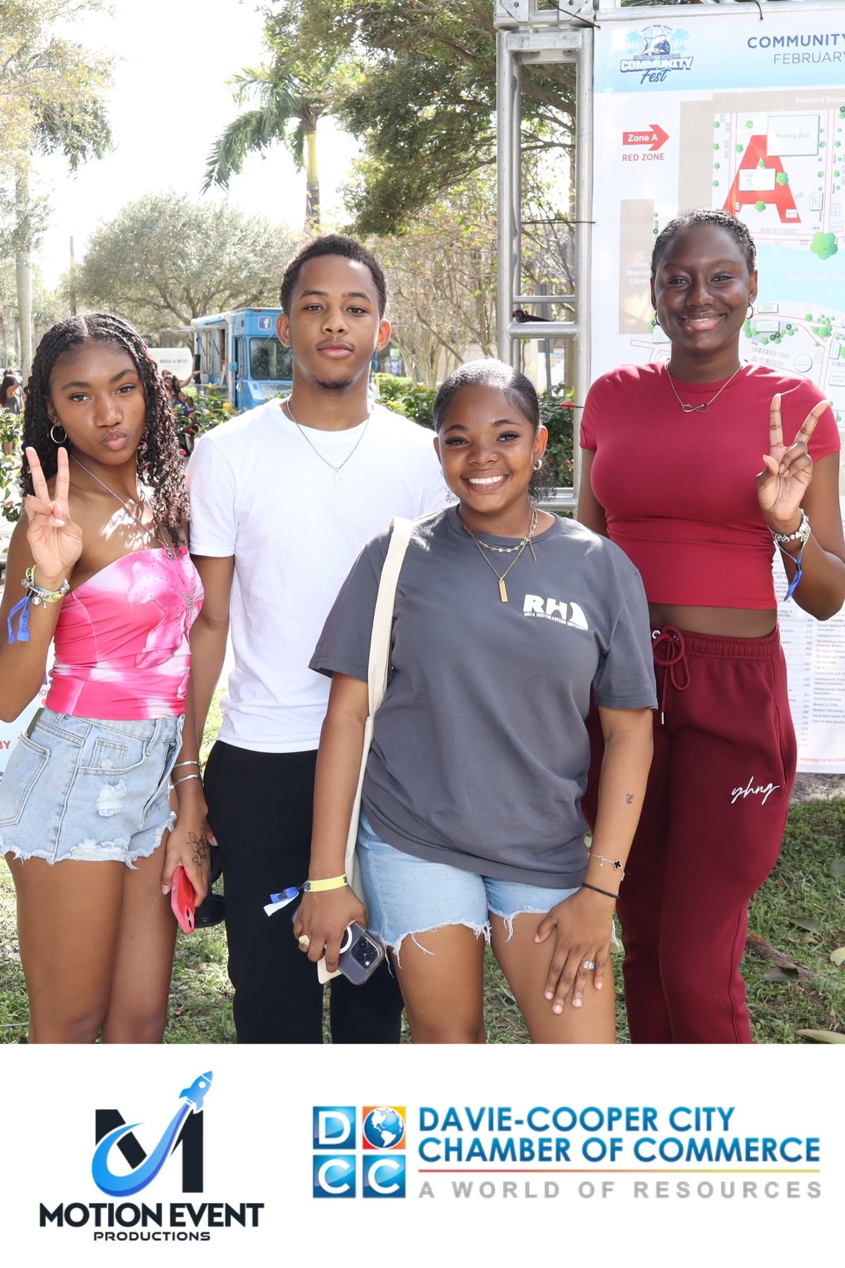 Four guests posing at a Motion photo booth at a Davie-Cooper City Chamber of Commerce community event