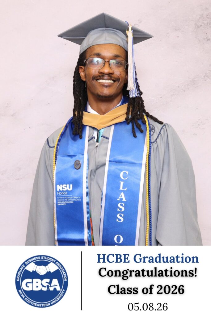 Graduate in cap and gown with a class of 2026 sash at a graduation photo booth