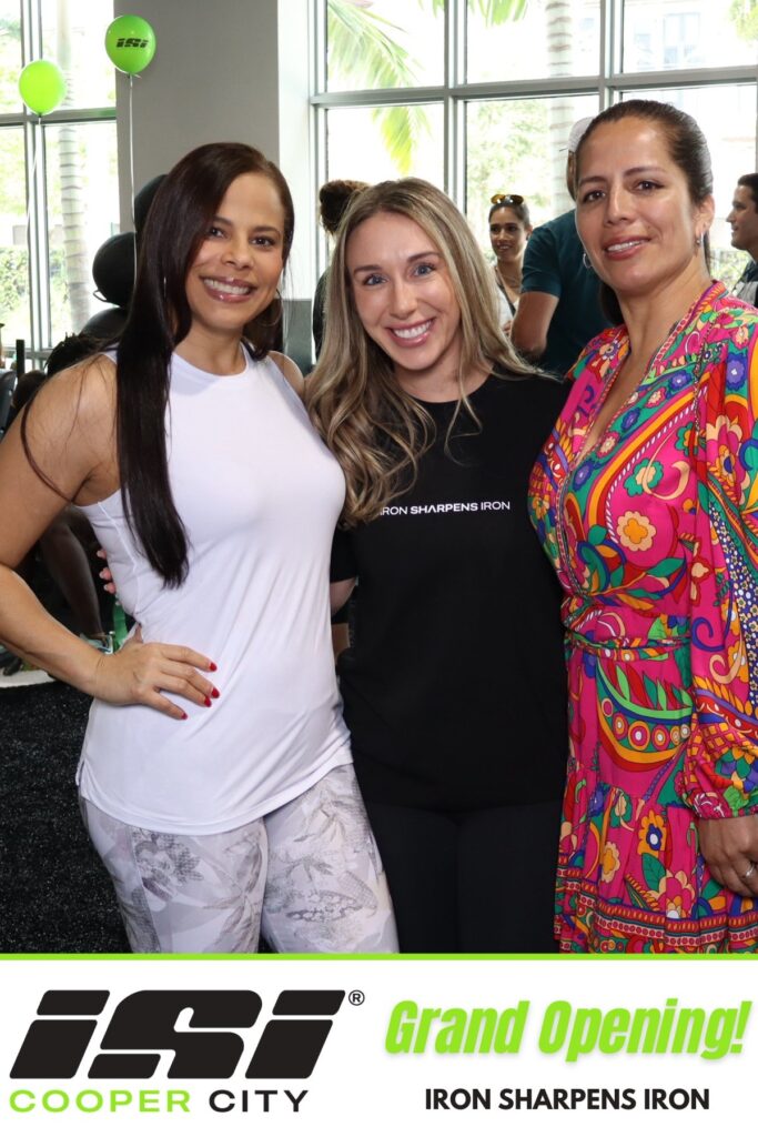 Three guests at a branded grand opening photo booth in Cooper City