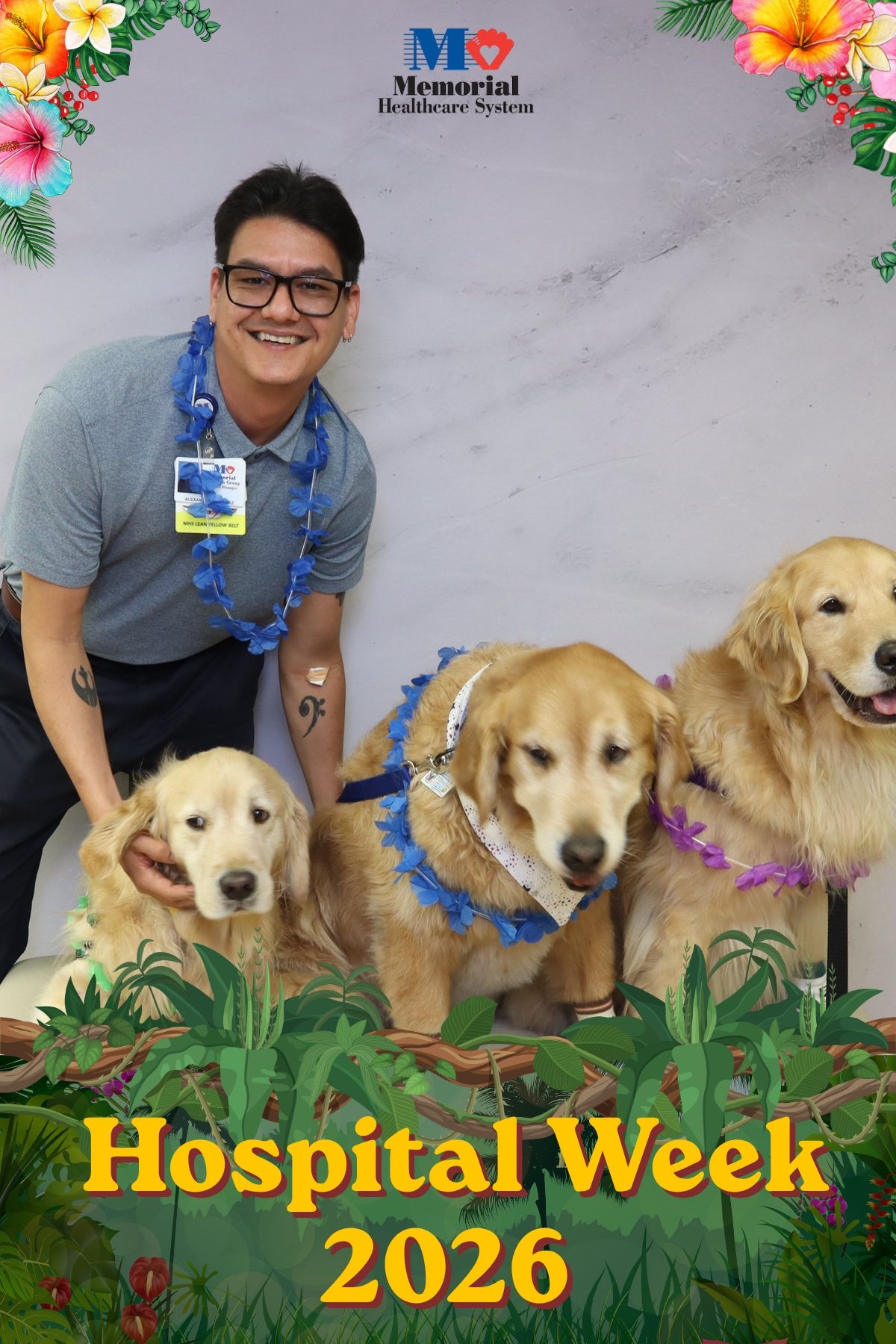 Hospital staff member with two therapy dogs at a Hospital Week photo booth
