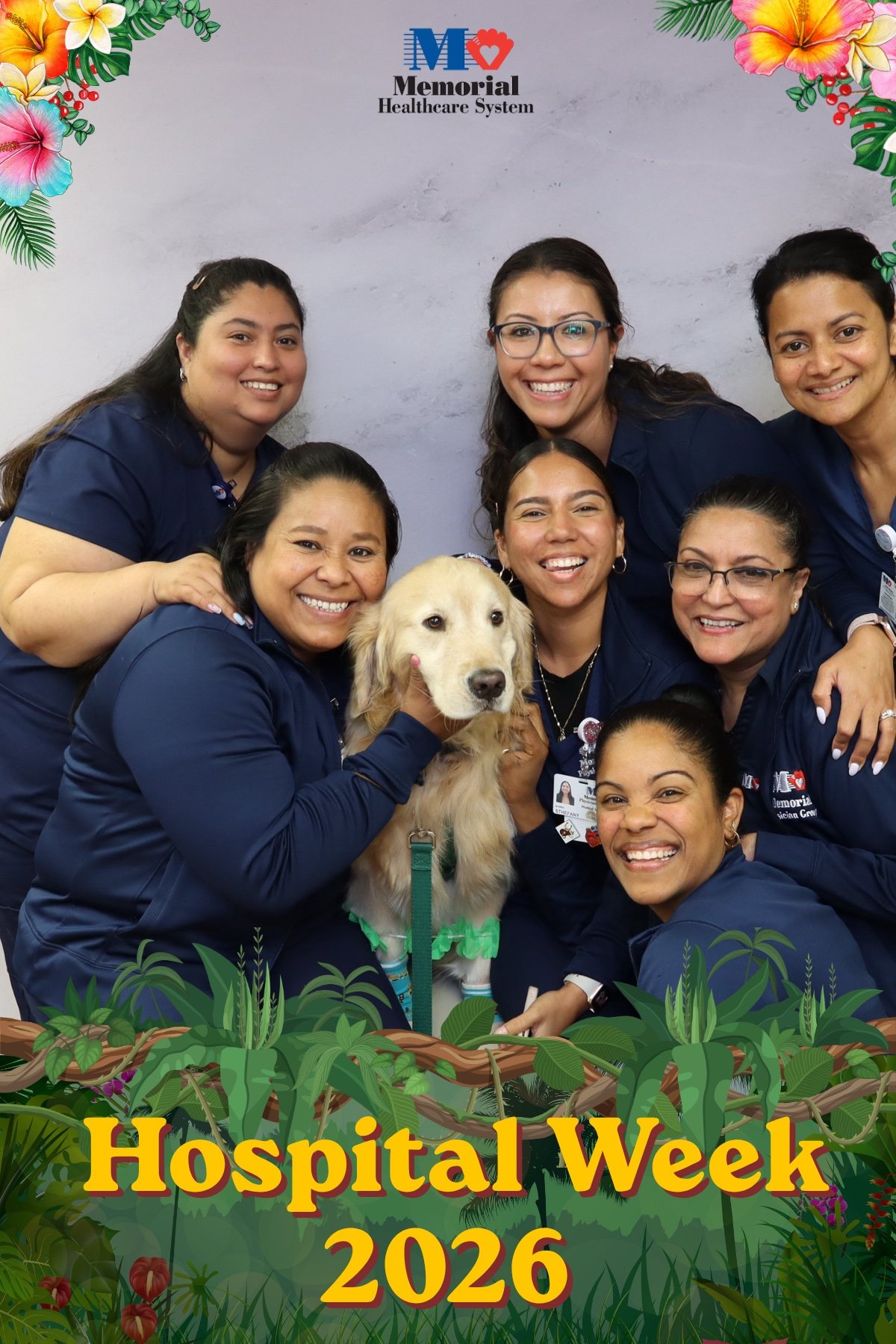 Group of hospital staff posing with a therapy dog at a Hospital Week photo booth