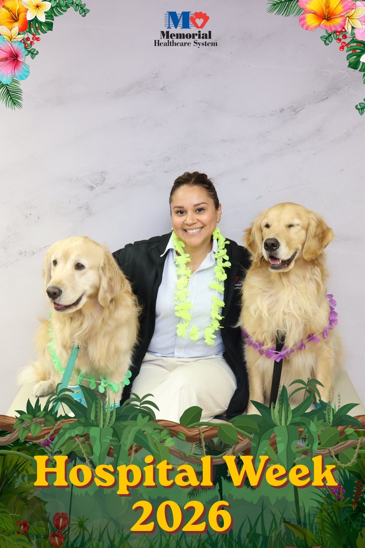 Hospital staff member with two golden retrievers at a staff appreciation photo booth