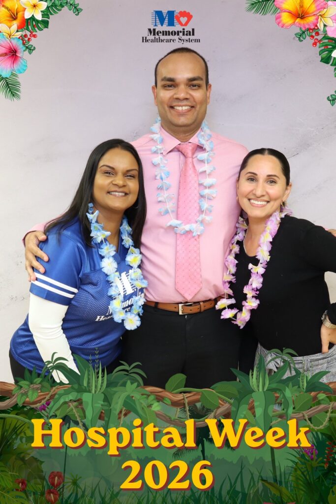 Three hospital staff in leis posing at a Hospital Week photo booth