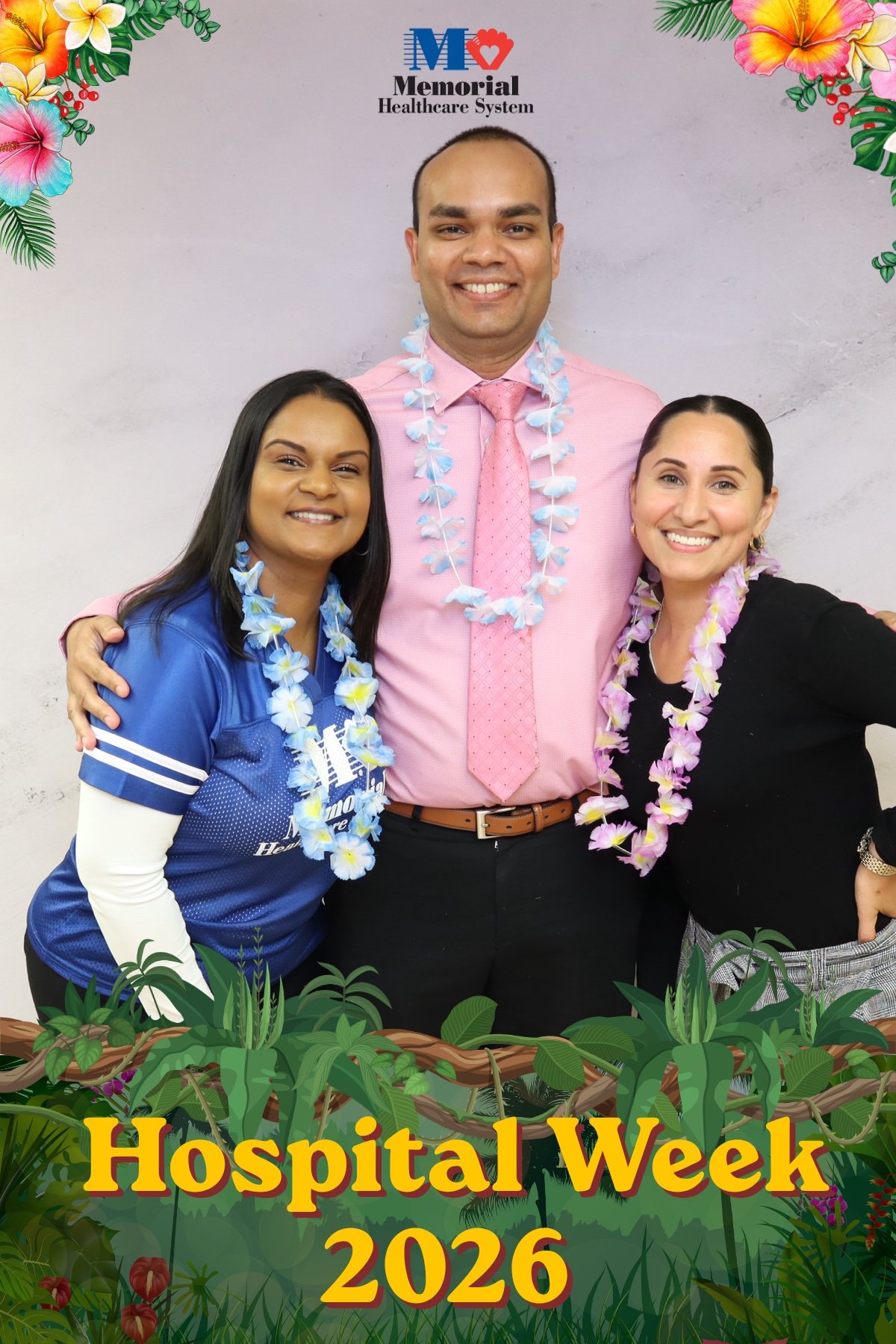 Three hospital staff in leis posing at a Hospital Week photo booth