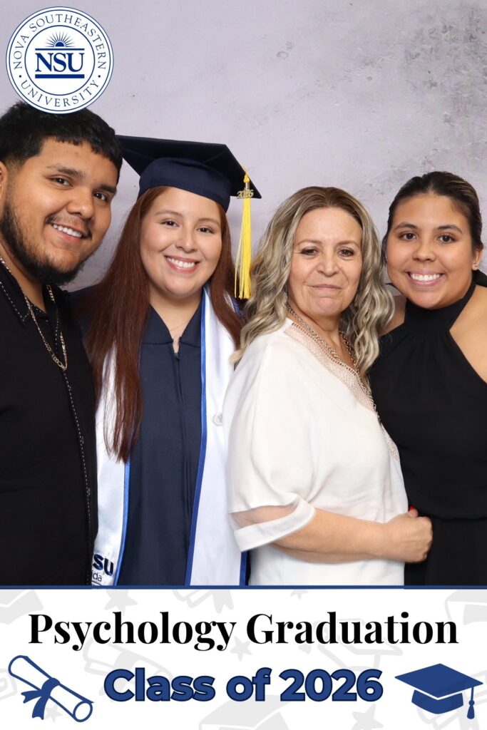 Graduate and family posing at a university graduation photo booth in South Florida