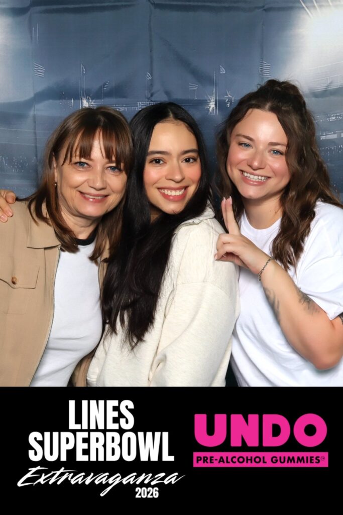 Three guests at a branded photo booth during a Super Bowl brand activation