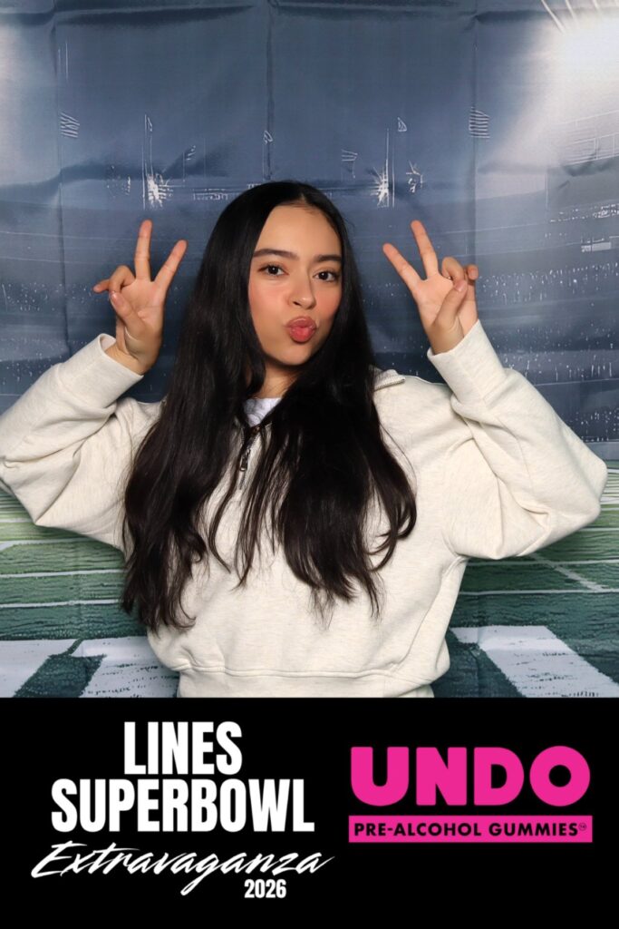 Guest posing at a branded photo booth during a Super Bowl activation